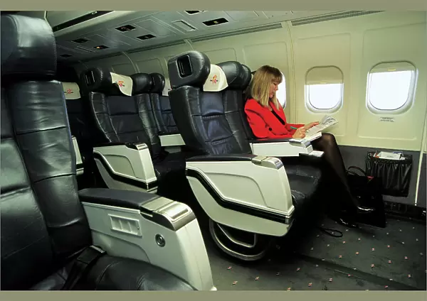 Female passenger in business class on MDC MD83 AOM airliner