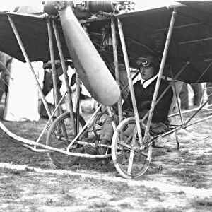Audemars sitting under his high-wing, wire-braced Demoiselle monoplane
