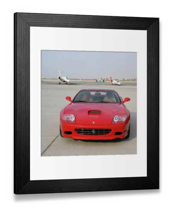 Framed Print : Ferrari car with executive jets at Dubai Airshow 2005
