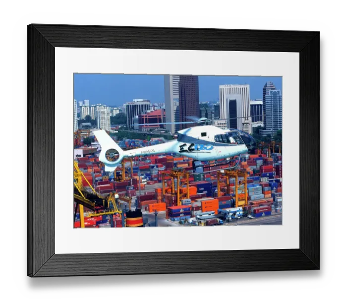 Framed Print : Eurocopter EC120 flying over Singapore docks Framed Print : Eurocopter EC120 flying over Singapore docks