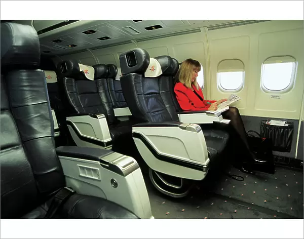Female passenger in business class on MDC MD83 AOM airliner