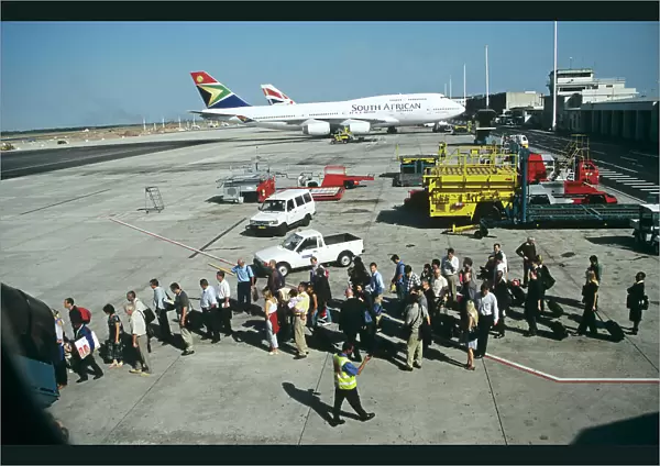 Passengers queue to board up steps at Jo berg Airport South Africa