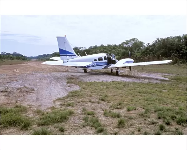Piper Seneca on dirt airstrip in Amazon jungle, South America