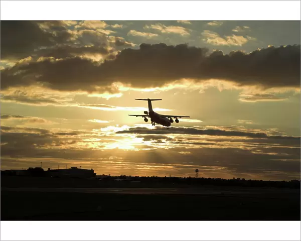 BAe 146 landing in sunset