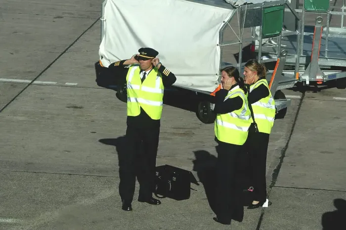 Framed Print : Aer Arran flight crew protecting hearing whilst standing on tarmac at Cork Airport, Ireland Framed Print : Aer Arran flight crew protecting hearing whilst standing on tarmac at Cork Airport, Ireland
