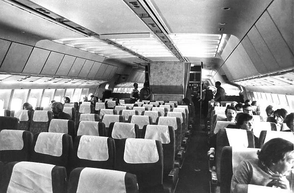 Airliner cabin in 1970s with passenger (front right) smoking on board