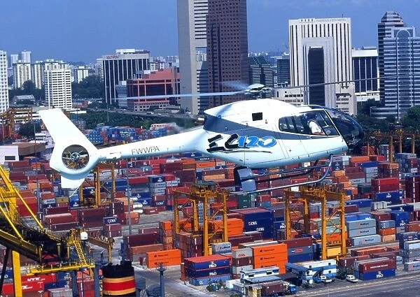 Eurocopter EC120 flying over Singapore docks