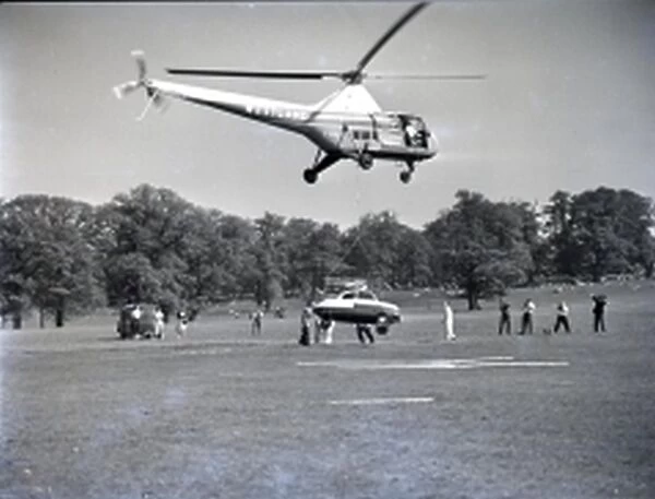 idgeon helicopter lifting a car at the international Helicopter Rally at Woburn Abbey (England), 1950's