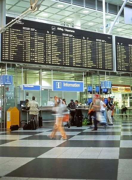 Interiors: Munich. info desks passengers blurred hurrying munich int airport