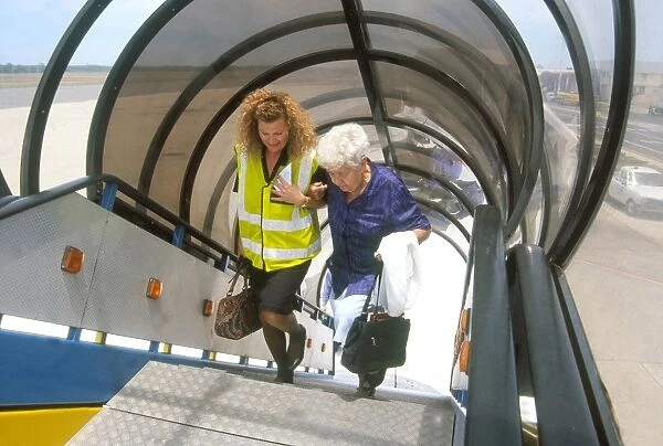 Passenger being helped up steps of British Airways aircraft in South Africa