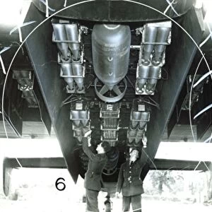 Crew of an RAF Halifax bomber load bombs, during World war Two