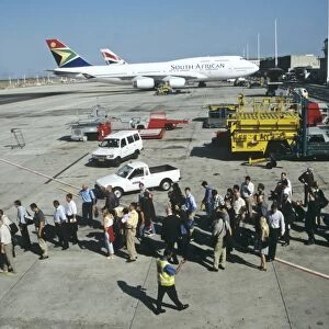 Passengers queue to board up steps at Jo berg Airport South Africa