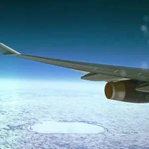 View from Boeing 747-400 flying over snowy fields