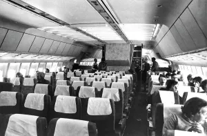 Airliner cabin in 1970s with passenger (front right) smoking on board Airliner cabin in 1970s with passenger (front right) smoking on board