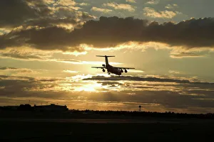 BAe 146 landing in sunset