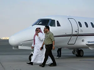 Businessmen walking past Cessna at Dubai Airshow 2005
