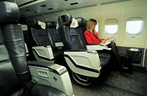 Female passenger in business class on MDC MD83 AOM airliner
