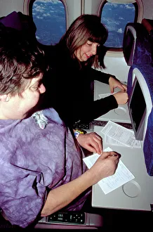 Interiors: filling in immigration forms on board aircraft Interiors: filling in immigration forms on board aircraft