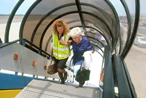Passenger being helped up steps of British Airways aircraft in South Africa Passenger being helped up steps of British Airways aircraft in South Africa