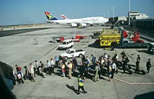 Passengers queue to board up steps at Jo berg Airport South Africa