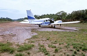 Piper Seneca on dirt airstrip in Amazon jungle, South America