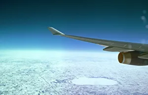 View from Boeing 747-400 flying over snowy fields